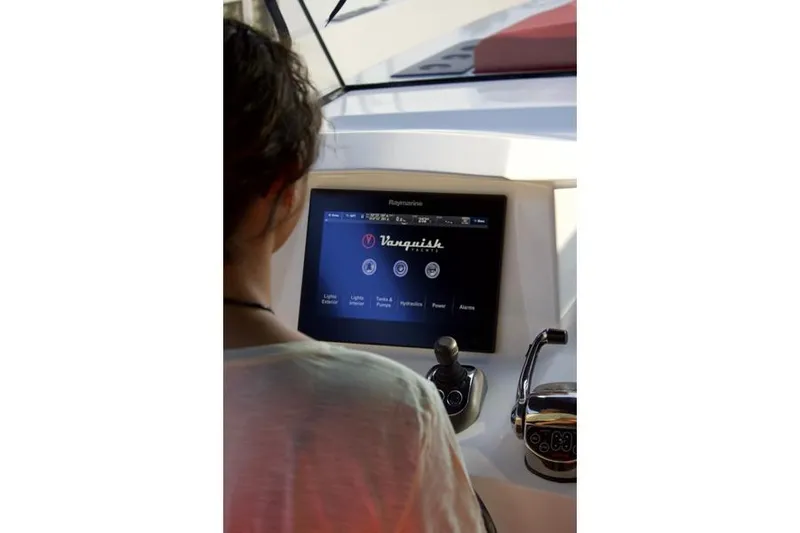 Aliyyah 29 Yacht Photos Pics Person operating Vanquish Yachts VQ45 2018 control panel with touchscreen interface.