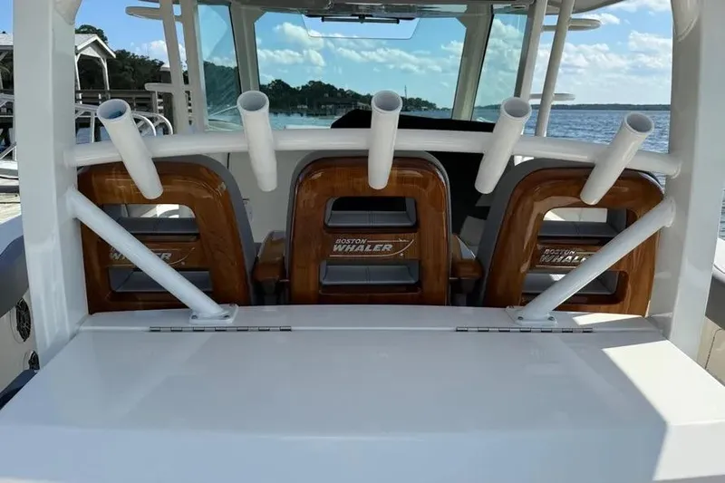  Yacht Photos Pics 2024 Boston Whaler 380 Outrage boat interior with rod holders and seating.