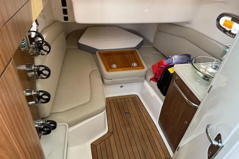  Yacht Photos Pics 2024 Boston Whaler 380 Outrage cabin interior with seating, table, and wood accents.