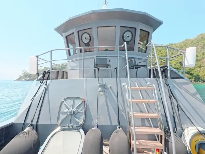 Risk Taker Yacht Photos Pics Tansu Custom Trawler 2006, docked with visible deck and cabin, surrounded by calm waters.