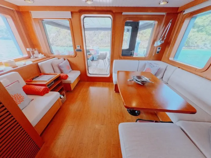 Risk Taker Yacht Photos Pics Luxurious interior of 2006 Tansu Custom Trawler with elegant seating and wooden finishes.
