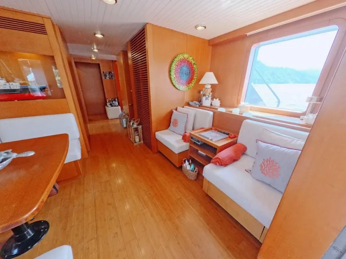 Risk Taker Yacht Photos Pics Luxurious interior of 2006 Tansu Custom Trawler with wooden decor and comfortable seating.