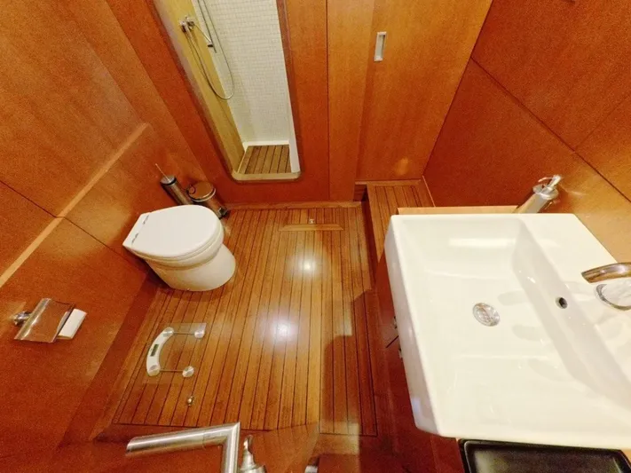 Risk Taker Yacht Photos Pics Luxurious 2006 Tansu Custom Trawler bathroom with wooden flooring and modern fixtures.