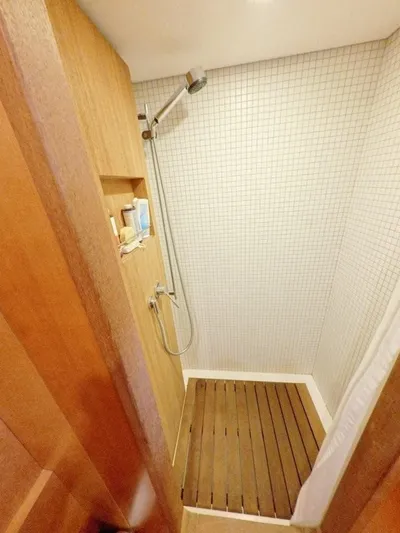 Risk Taker Yacht Photos Pics Shower area in 2006 Tansu Custom Trawler with wooden floor and tiled walls.