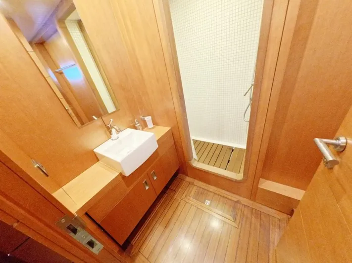 Risk Taker Yacht Photos Pics Bathroom interior of 2006 Tansu Custom Trawler with wooden finish and modern fixtures.