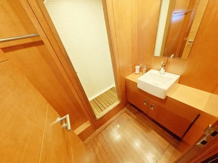 Risk Taker Yacht Photos Pics Luxurious wooden bathroom interior on 2006 Tansu Custom Trawler yacht, featuring modern sink and shower.