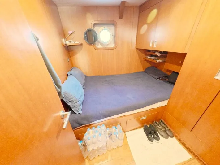 Risk Taker Yacht Photos Pics Cozy cabin interior of 2006 Tansu Custom Trawler with bed, porthole, and storage.