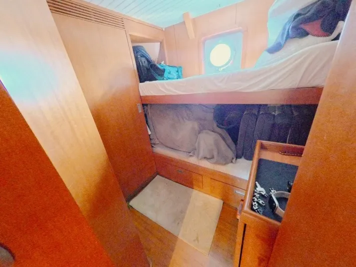 Risk Taker Yacht Photos Pics Cozy cabin interior of 2006 Tansu Custom Trawler with bunk beds and wooden furnishings.
