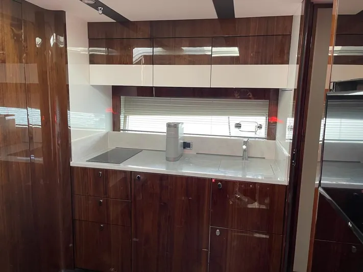  Yacht Photos Pics Luxurious kitchen interior of 2020 Fairline 45/43 Targa yacht with sleek cabinetry.