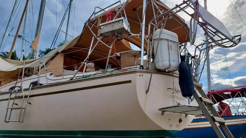 Azafran Yacht Photos Pics 1994 Island Packet 40 sailboat docked, featuring tan canopy and stainless steel rigging.