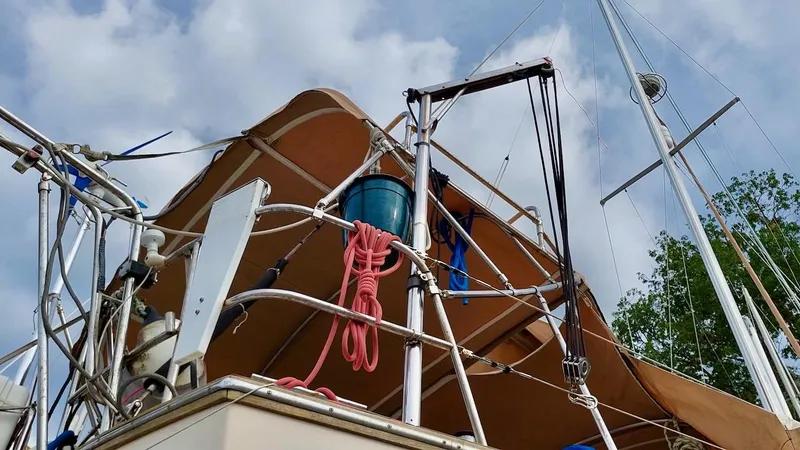 Azafran Yacht Photos Pics 1994 Island Packet 40 sailboat deck with rigging and canopy under cloudy sky.