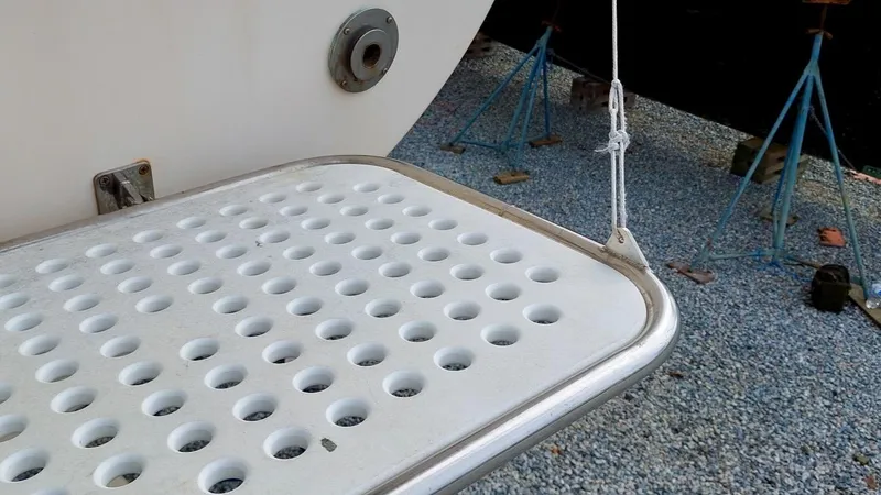 Azafran Yacht Photos Pics Perforated swim platform on a 1994 Island Packet 40 sailboat, supported by stands.