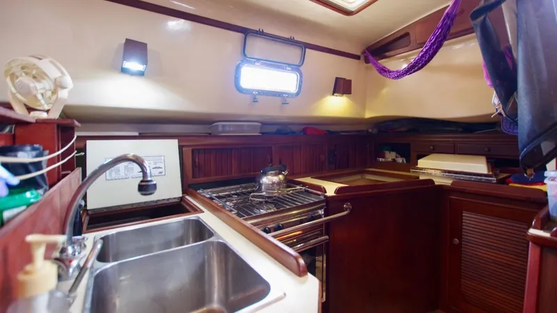 Azafran Yacht Photos Pics Interior of 1994 Island Packet 40 sailboat kitchen with sink and stove.