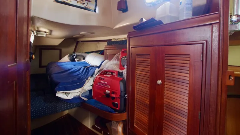 Azafran Yacht Photos Pics Cozy cabin interior of 1994 Island Packet 40 sailboat with wooden cabinetry and bedding.