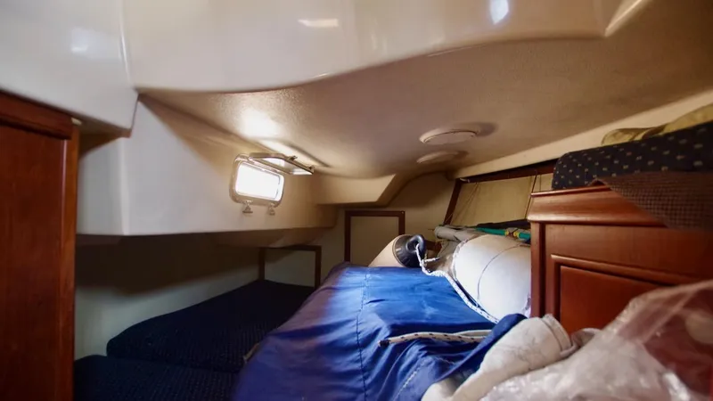 Azafran Yacht Photos Pics Cozy cabin interior of a 1994 Island Packet 40 sailboat with bedding and storage.
