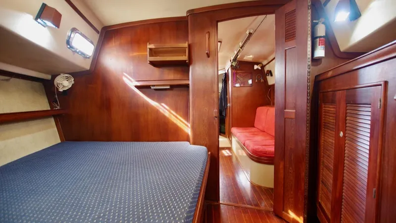 Azafran Yacht Photos Pics Interior of 1994 Island Packet 40 sailboat with wooden finish and cozy seating area.