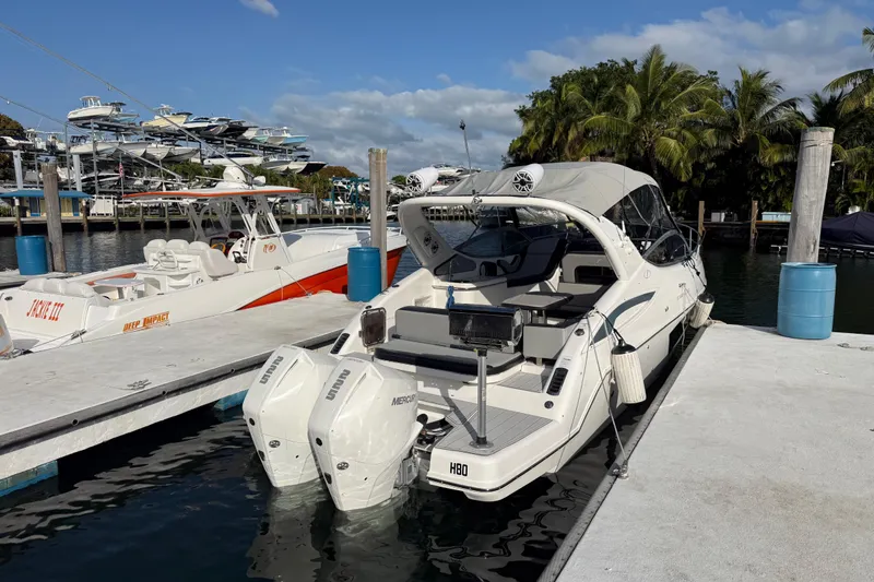  Yacht Photos Pics 2021 Schaefer 303 boat docked at marina with palm trees and clear sky.