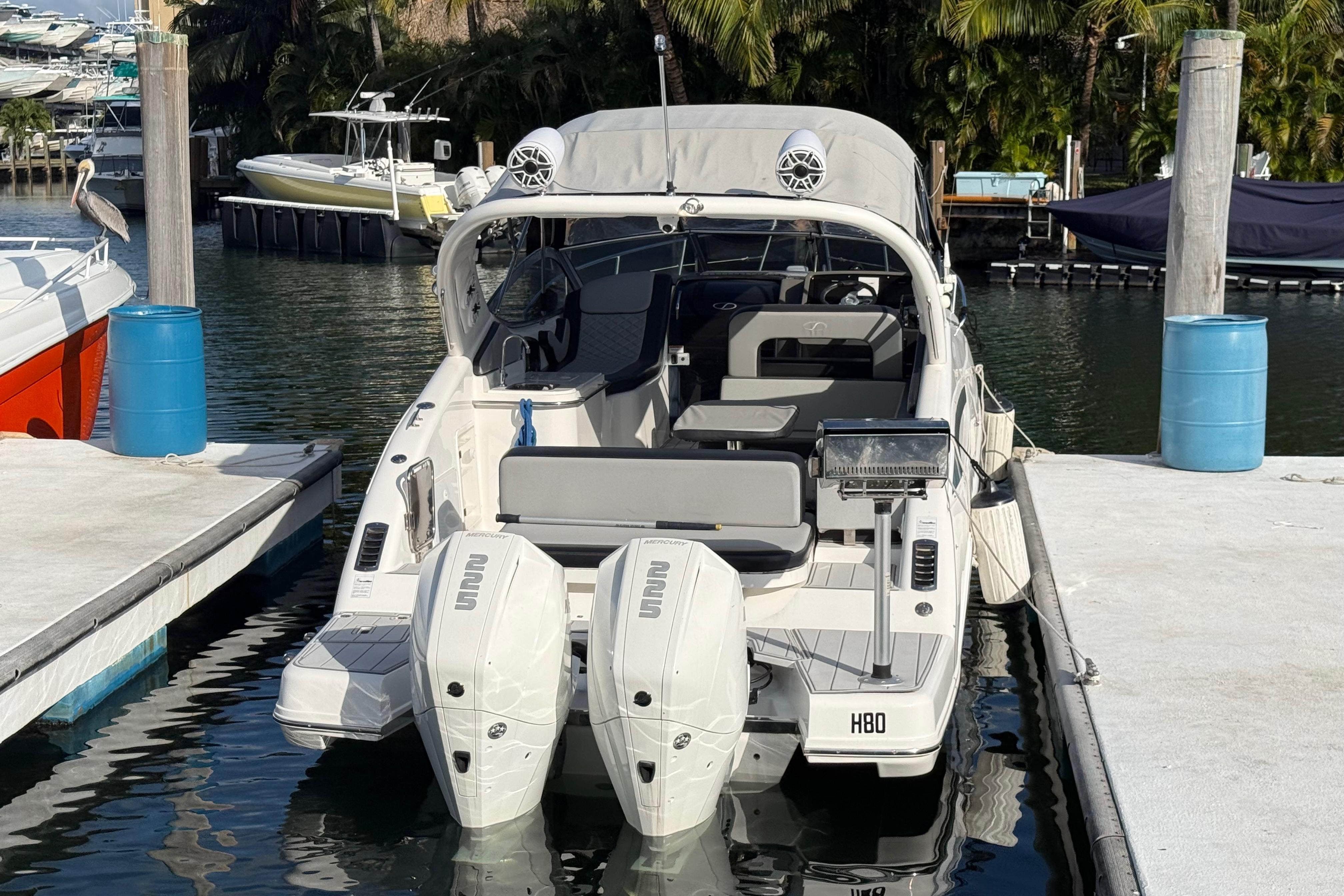 Schaefer 303 boat docked, 2021 model, with dual engines and sleek design.