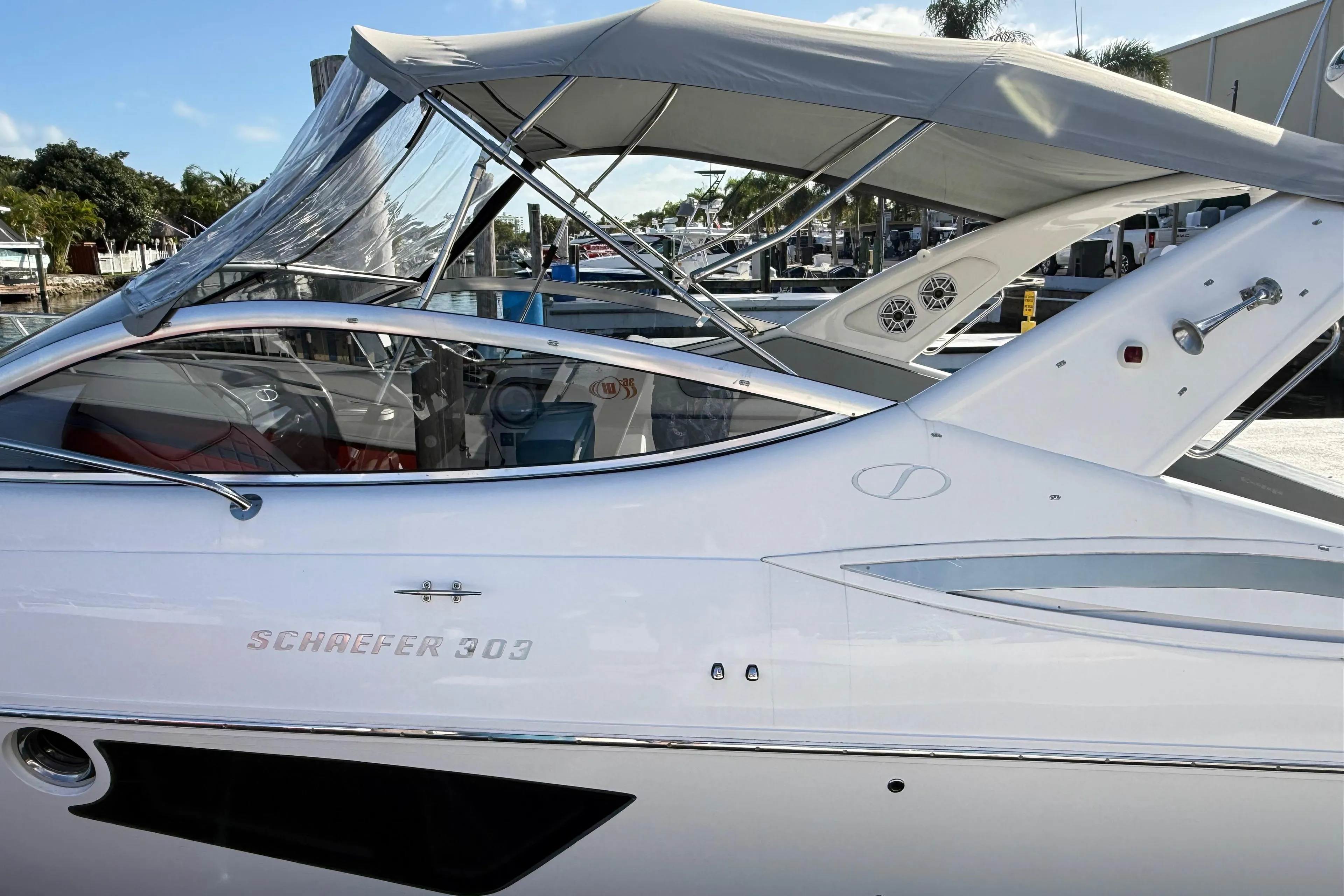 Schaefer 303 boat, 2021 model, docked with canopy and sleek design.