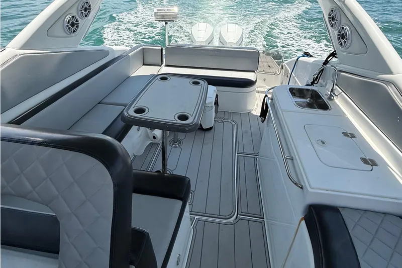  Yacht Photos Pics Luxurious 2021 Schaefer 303 yacht interior with seating, table, and kitchenette on open water.
