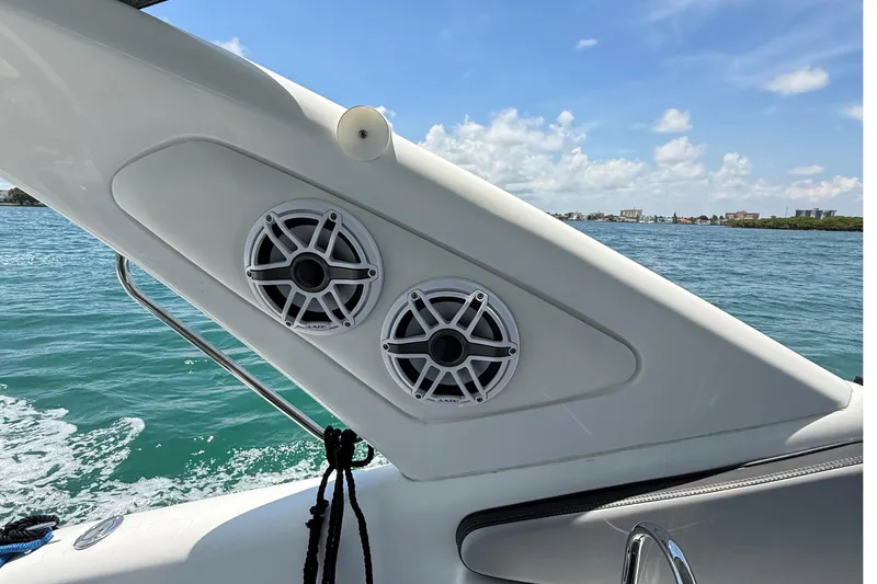  Yacht Photos Pics Boat speakers on a 2021 Schaefer 303, with ocean and cityscape in the background.