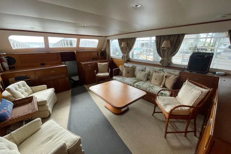 Georgia Yacht Photos Pics Interior of a 1967 Huckins Offshore yacht with cozy seating and wooden furnishings.