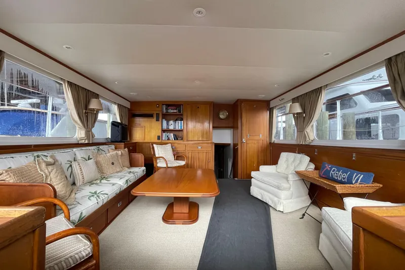 Georgia Yacht Photos Pics Interior of a 1967 Huckins Offshore yacht with elegant wood paneling and comfortable seating.