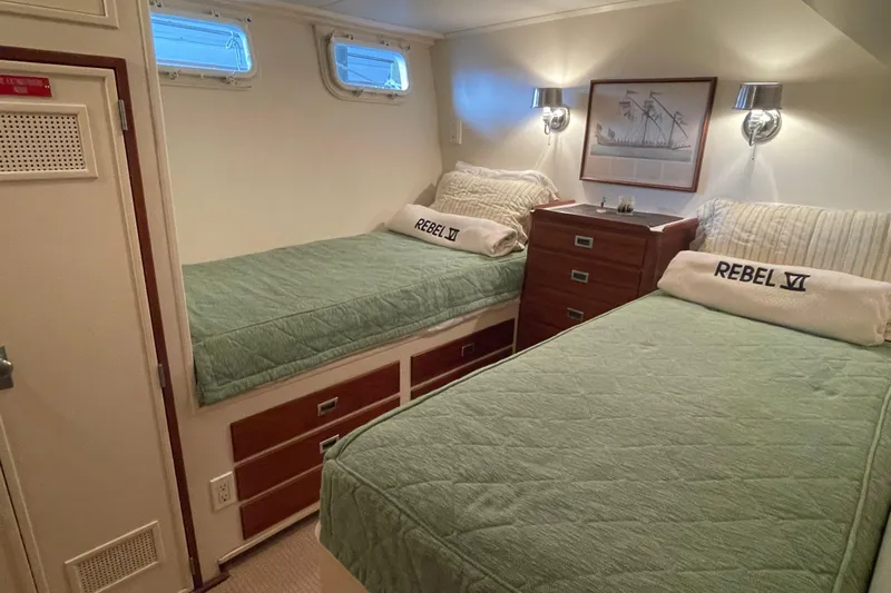 Georgia Yacht Photos Pics Cozy twin cabin on 1967 Huckins Offshore yacht with green bedding and nautical decor.