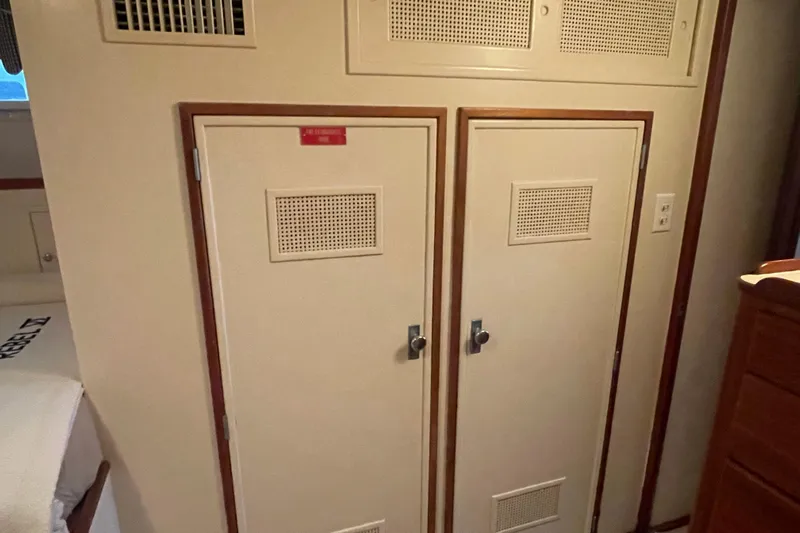 Georgia Yacht Photos Pics Interior of 1967 Huckins Offshore yacht with dual storage cabinets and wood trim.