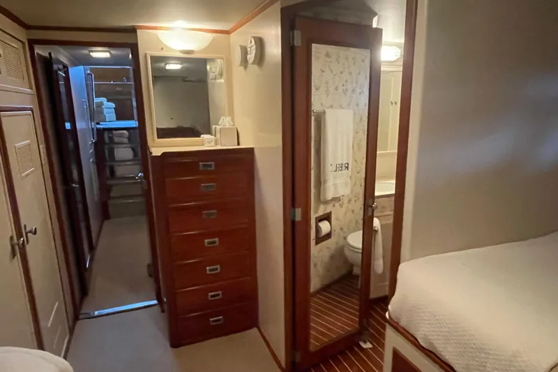 Georgia Yacht Photos Pics 1967 Huckins Offshore yacht interior with wooden cabinetry and bathroom.