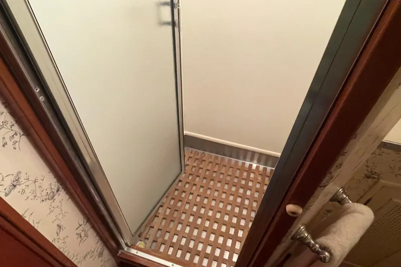 Georgia Yacht Photos Pics Shower area in a 1967 Huckins Offshore boat with wooden floor grating.