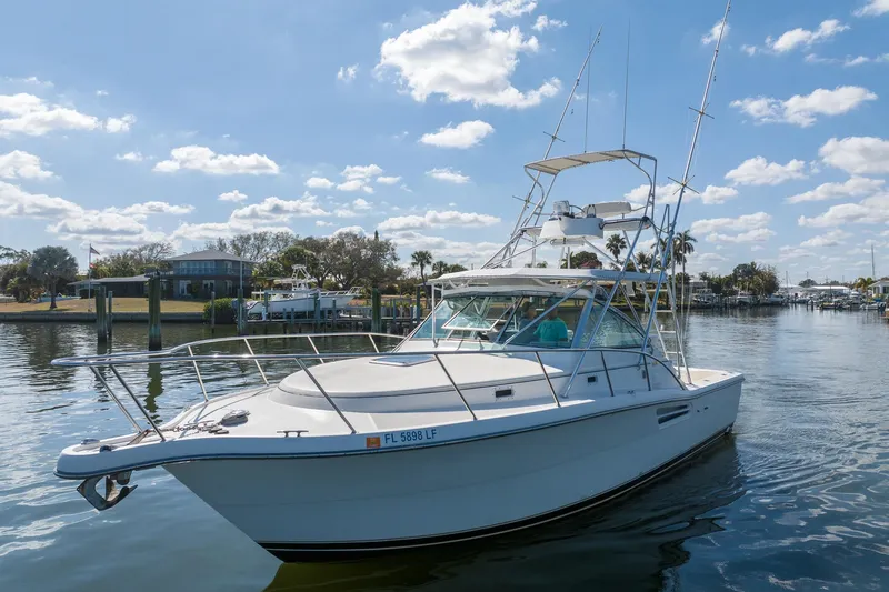  Yacht Photos Pics 1997 Tiara Yachts 3500 Express cruising on a sunny day, dockside view.