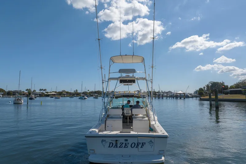  Yacht Photos Pics 1997 Tiara Yachts 3500 Express boat named "Daze Off" on calm water under blue sky.