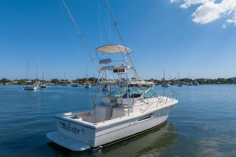  Yacht Photos Pics 1997 Tiara Yachts 3500 Express boat on calm water, clear blue sky background.