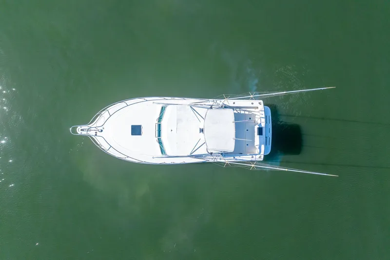  Yacht Photos Pics Overhead view of 1997 Tiara Yachts 3500 Express on calm green water.