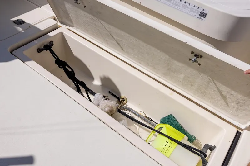  Yacht Photos Pics Storage compartment on a 1997 Tiara Yachts 3500 Express, containing various boating accessories.