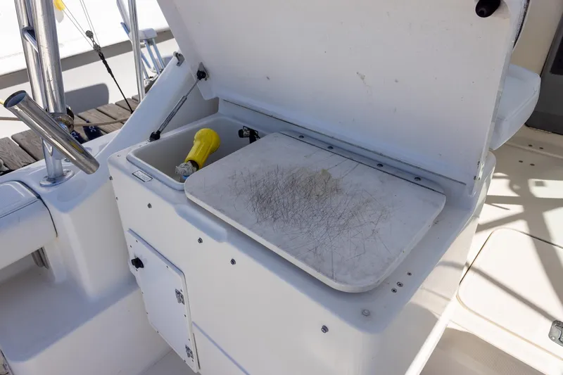  Yacht Photos Pics 1997 Tiara Yachts 3500 Express boat with open storage compartment and cutting board.