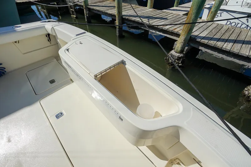  Yacht Photos Pics 1997 Tiara Yachts 3500 Express boat deck with storage compartment, docked at marina.