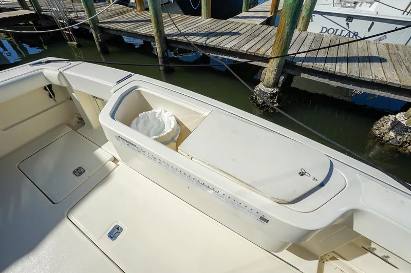  Yacht Photos Pics 1997 Tiara Yachts 3500 Express boat deck with storage compartment and dock view.