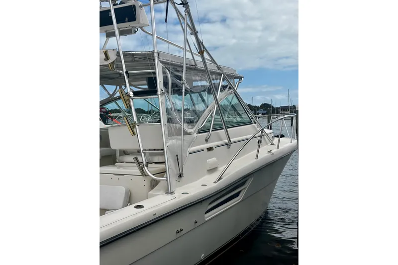 Yacht Photos Pics 1997 Tiara Yachts 3500 Express boat docked, featuring sleek design and sturdy railings.