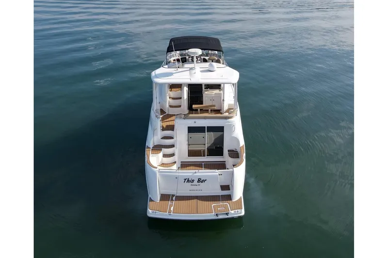 This Bar Yacht Photos Pics 2004 Meridian 459 Motoryacht on calm water, rear view showcasing deck and cabin.