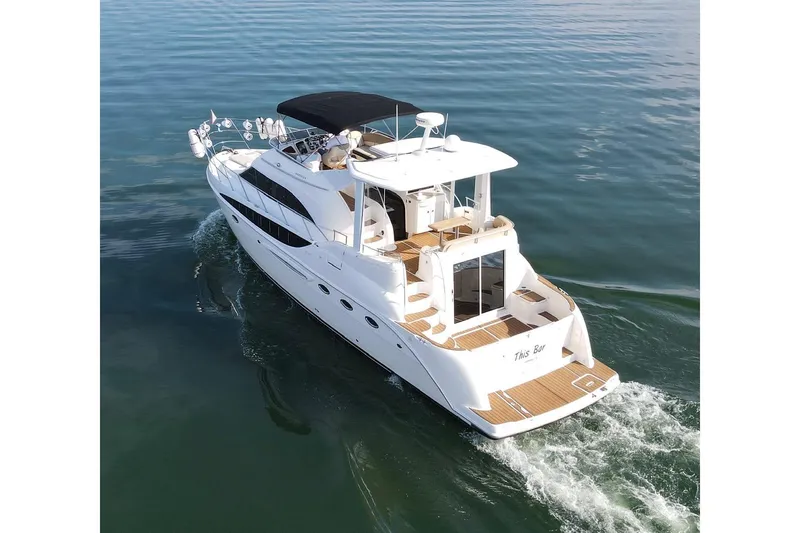 This Bar Yacht Photos Pics 2004 Meridian 459 Motoryacht cruising on calm waters, rear view.