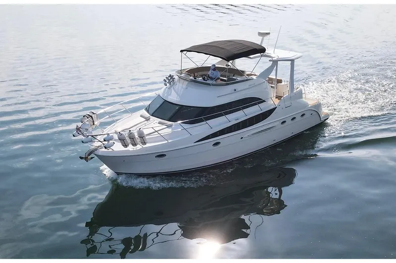 This Bar Yacht Photos Pics 2004 Meridian 459 Motoryacht cruising on calm waters under clear skies.