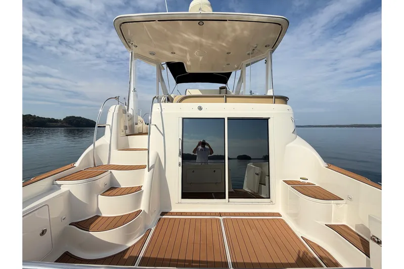 This Bar Yacht Photos Pics 2004 Meridian 459 Motoryacht with elegant deck and scenic water view.