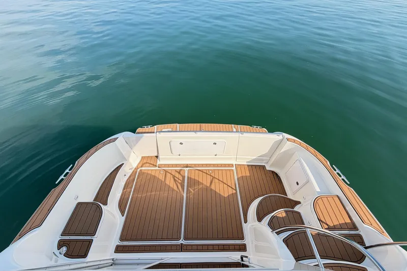 This Bar Yacht Photos Pics 2004 Meridian 459 Motoryacht deck with teak flooring on calm water.