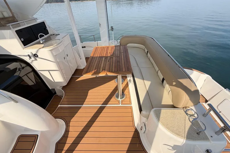 This Bar Yacht Photos Pics Luxurious 2004 Meridian 459 Motoryacht deck with seating, table, and kitchenette.