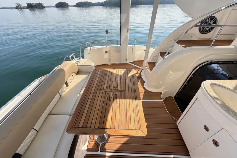 This Bar Yacht Photos Pics Luxurious 2004 Meridian 459 Motoryacht deck with elegant wood finish and scenic water view.