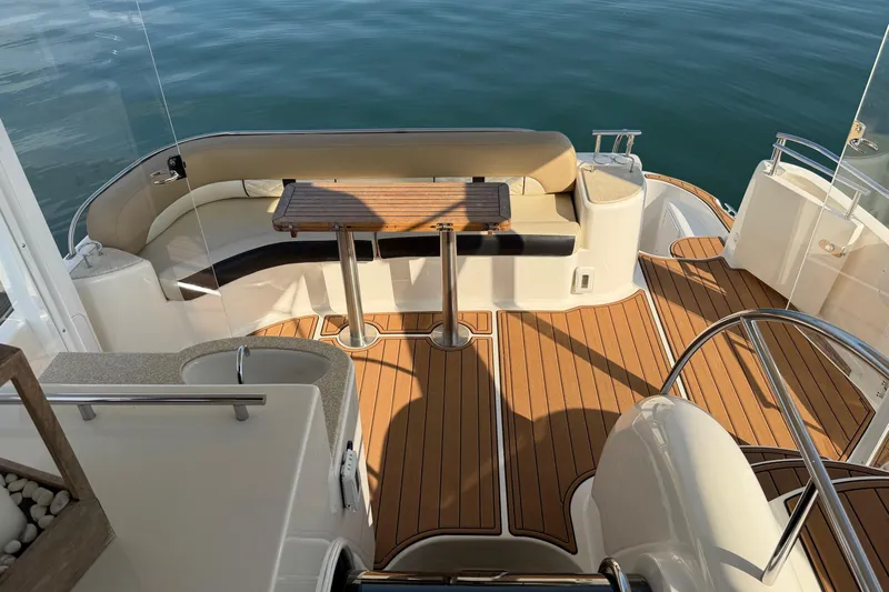 This Bar Yacht Photos Pics 2004 Meridian 459 Motoryacht deck with seating, table, and teak flooring.