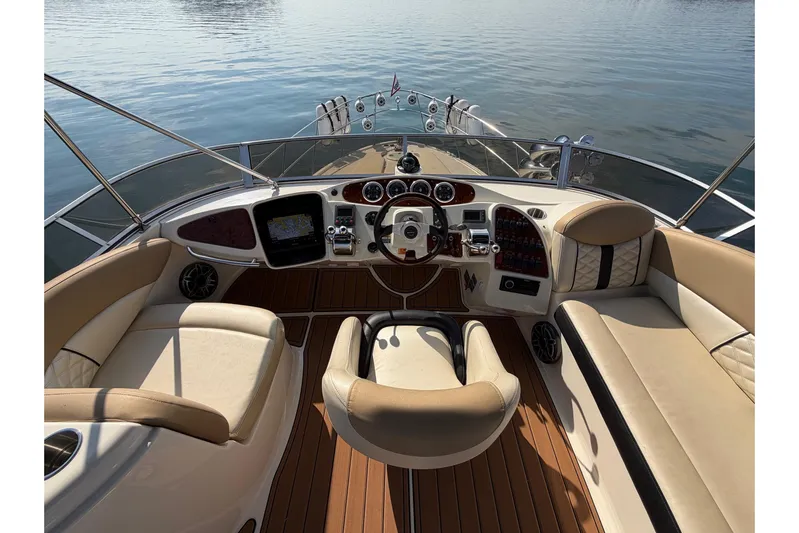 This Bar Yacht Photos Pics 2004 Meridian 459 Motoryacht helm with luxurious seating and modern controls on calm water.