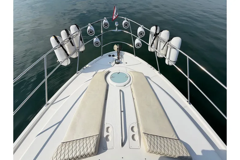 This Bar Yacht Photos Pics 2004 Meridian 459 Motoryacht bow with fenders and speakers on calm water.